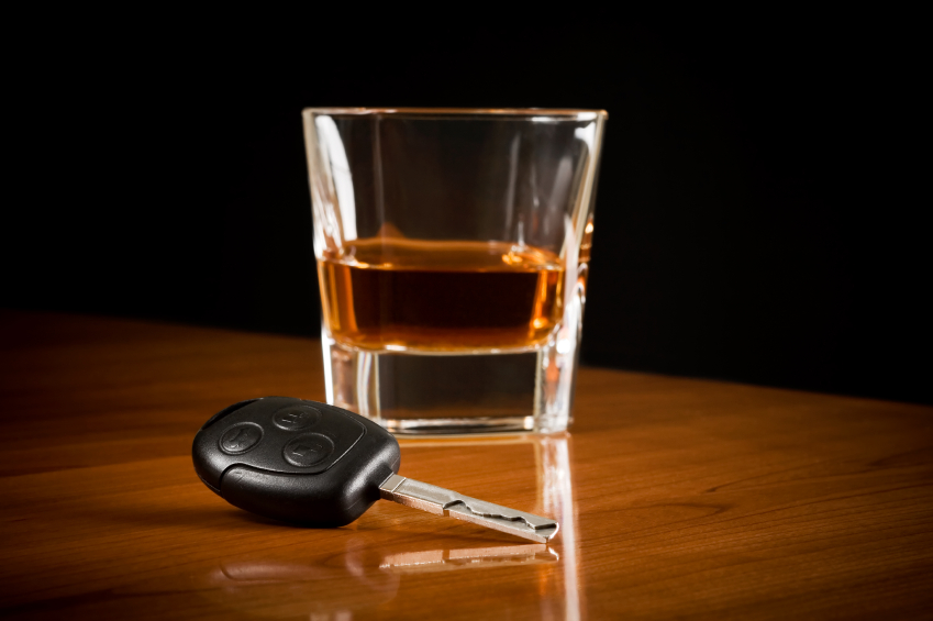 Alcohol on table with a car key.