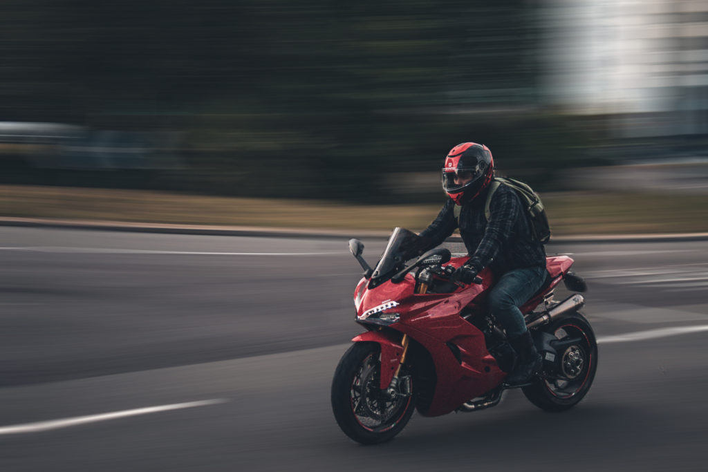 an image of a motorbiker moving very fast.