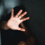 A pleading hand being held out for help.