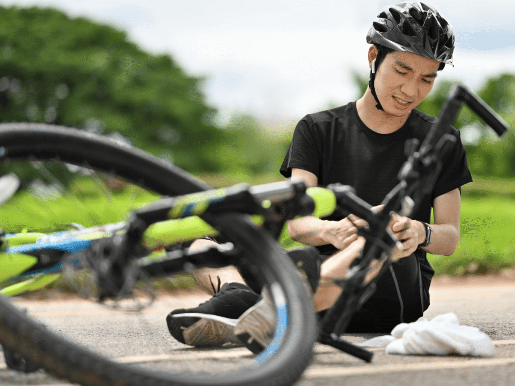 Cyclist on the ground with bicycle after an accident