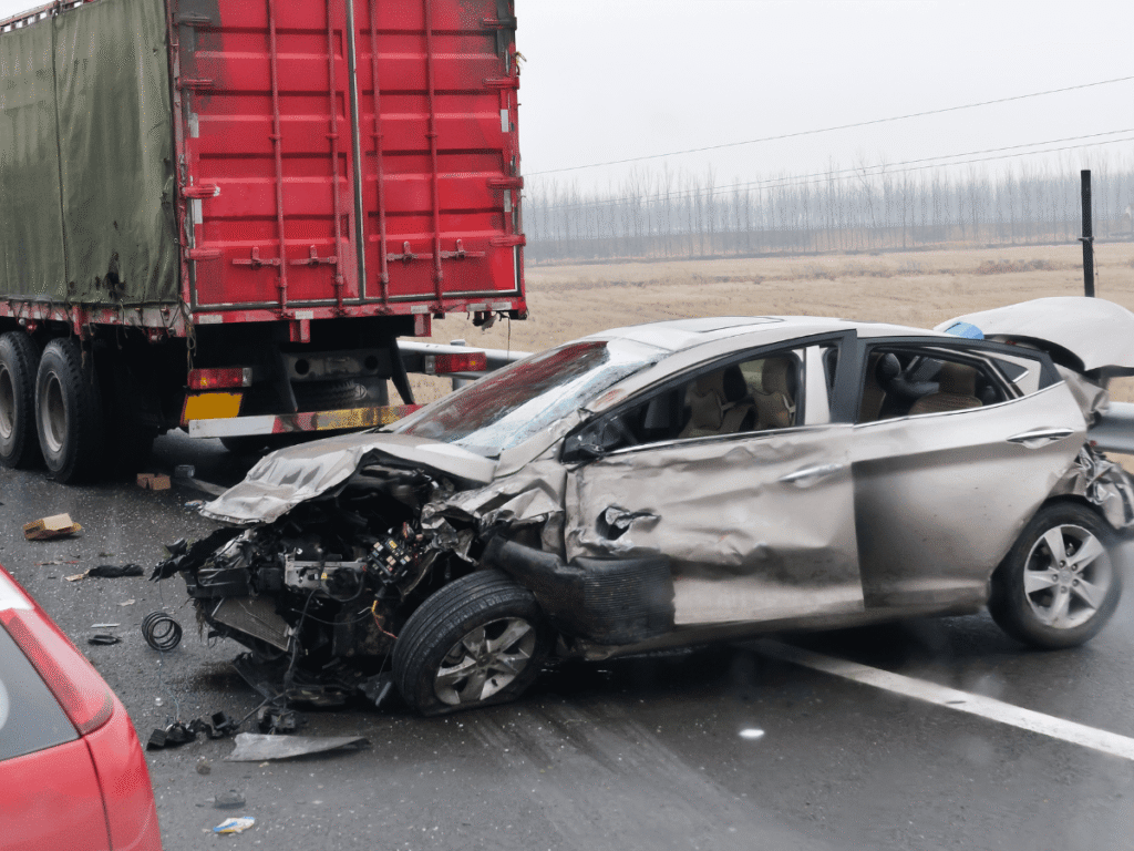 Severe car damage after collision with truck