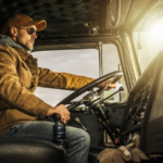 Commercial truck driver sitting behind the wheel of a semi-truck cab, representing the serious consequences a Wyoming CDL DUI conviction can have on a commercial driver’s career and license.
