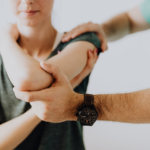 Medical professional examines a patient’s arm injury, illustrating the importance of medical documentation and evidence in personal injury claims.