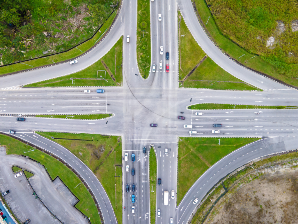 Graphic illustrating a blog about intersection accident witnesses in Gillette, featuring an aerial view of a busy multi-lane intersection with vehicles traveling in multiple directions.