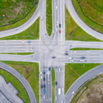 Graphic illustrating a blog about intersection accident witnesses in Gillette, featuring an aerial view of a busy multi-lane intersection with vehicles traveling in multiple directions.